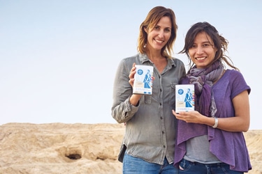 women holding blue boxes